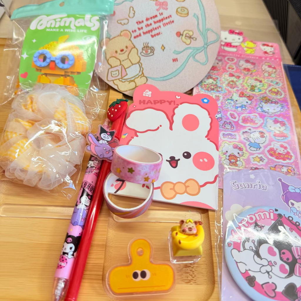 Example of Toffee's Tiny Treasure Scoop, including various stationeries such as highlighter, scrunchy, wristband, kawaii pen, pocket mirror, coaster, mini pocketbook, building block, memo clip, fidget key